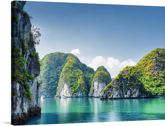This stunning print captures the breathtaking beauty of Ha Long Bay, Vietnam. The image showcases the bay’s emerald waters, towering limestone islands covered with greenery, and clear blue skies with few clouds. 