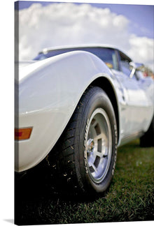  Capture the essence of classic automotive elegance with this stunning print featuring a close-up view of a pristine white vintage car. The artwork accentuates the car’s sleek curves, gleaming surface, and iconic wheel design, set against a backdrop of a vivid blue sky dotted with fluffy clouds. This print is a perfect piece for car enthusiasts and art lovers alike, bringing a touch of nostalgia and sophistication to any space. 