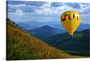 “Sunset.Balloon 2” captures the serene beauty of a hot air balloon’s journey across the majestic landscape. The vibrant, multicolored balloon contrasts beautifully against a backdrop of rolling hills and mountains, kissed by the gentle touch of the setting sun. The golden hues of wild grass in the foreground sway gracefully, echoing the freedom and tranquility experienced in this ethereal moment. 