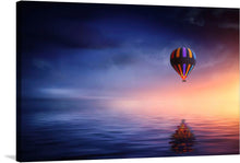   This print captures a serene moment of a colorful hot air balloon ascending against the backdrop of a tranquil sunset. The harmonious blend of the deep blue sky and the warm hues of the setting sun creates an enchanting atmosphere that invites calmness and reflection.