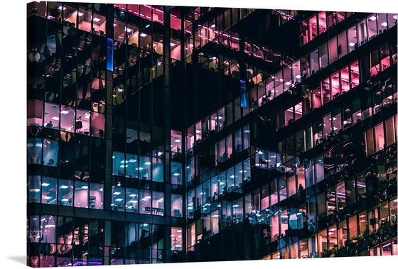 This exclusive print captures the mesmerizing dance of lights and shadows in a city that never sleeps. Each window in the modern building tells a unique story, reflecting vibrant hues of pinks, blues, and purples that breathe life into the architectural marvel. The faintly visible silhouettes and interior details within each window add depth to the image, creating a visually striking effect. 
