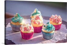  Dive into a world where culinary artistry meets visual splendor with “Blue and Pink Cupcakes”. This exquisite print captures the delicate dance of pastel hues, where swirls of serene blue and blushing pink icing adorn sumptuous cupcakes. Each cupcake, nestled in vibrant cases, is a testament to the artist’s mastery in rendering lifelike textures and tantalizing colors. 