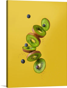  This stunning piece of art is sure to brighten up any room with its bold colors and playful composition. The sliced kiwis and blueberries on a yellow background create a refreshing and lively atmosphere that will leave you feeling energized and inspired. This artwork is available as a print, so you can enjoy its beauty in your own home.