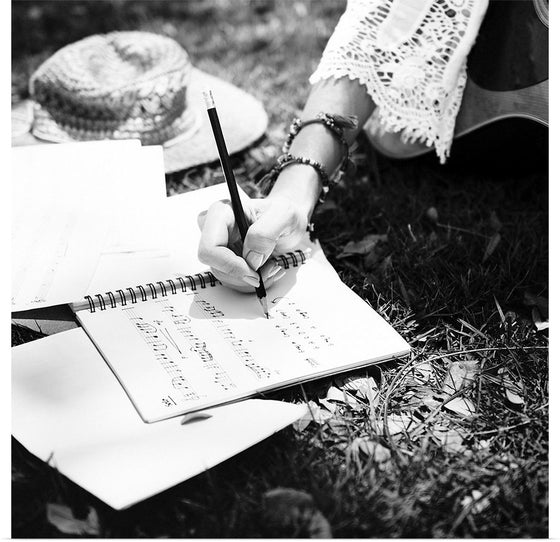 "Woman writing down some lyrics"