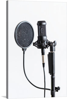  Capture the essence of sound and silence with this exquisite print of a professional studio microphone. Poised and ready for the next performance, the stark contrast between the intricate design of the microphone and the minimalist background evokes a sense of anticipation. 