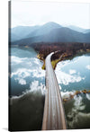 “Sylvenstein Dam, Germany” invites you to a harmonious blend of nature and engineering. This captivating print captures the majestic Sylvenstein Dam stretching across tranquil waters, nestled amidst lush greenery and framed by majestic mountains. The reflection of clouds on the water’s surface adds an ethereal touch, making this artwork a symphony of motion and stillness. 