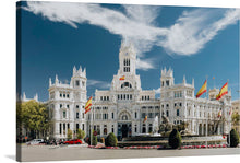  Immerse yourself in the grandeur and elegance of this exquisite print capturing the iconic architecture of a majestic white building adorned with intricate designs, standing proudly under the azure sky. Each detail, from the fluttering flags to the lush greenery surrounding it, is captured with impeccable clarity, inviting viewers into a world where artistry and history converge.