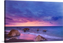  Immerse yourself in the serene beauty of this exquisite print, capturing a tranquil seaside at dusk. The harmonious dance of the vibrant hues of sunset, with purples, pinks, and blues painting the sky, creates a mesmerizing backdrop. The gentle waves kiss the sandy shore where majestic rocks stand as silent witnesses to nature’s awe-inspiring spectacle. 