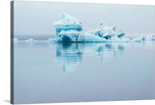  “White Iceberg in Sea”: Immerse yourself in the serene beauty of this captivating print. The artwork transports you to the tranquil waters of the Arctic, where majestic icebergs float gracefully. Their intricate designs, carved by nature, evoke wonder. Soft hues of blue and white intertwine, reflecting a dance between the ice and the sea. 