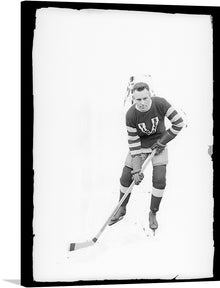  This striking black-and-white photograph captures the dynamic presence of Art Duncan, a star defenseman for the Vancouver Millionaires in the early 20th century. Duncan was known for his aggressive style of play, his ability to clear the puck from his own zone, and his booming slap shot. He was also a key member of the Millionaires' dynasty, which won the Stanley Cup three times in four years from 1915 to 1919.