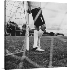  “Male Goalkeeper Standing by the Goal” is a stunning print that captures the intensity and passion of the beautiful game. The monochromatic tones elevate the drama, immortalizing a moment where anticipation and focus are as tangible as the cool metal goalpost and the sturdy boots that grace the earth.