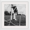 "Male goalkeeper standing by the goal"