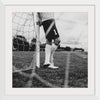 "Male goalkeeper standing by the goal"