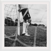 "Male goalkeeper standing by the goal"