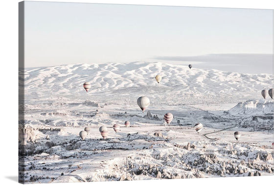 Elevate your space with this mesmerizing print capturing a serene and magical moment where hot air balloons gracefully float above a pristine, snow-covered landscape. The gentle hues of dawn kiss the earth, illuminating the intricate patterns carved by nature into the rolling hills and valleys. Each balloon, adorned with unique designs, adds a splash of color to the tranquil white expanse below. 