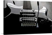  This gorgeous black and white print of an electric guitar is a must-have for any music lover or art collector. The guitar is depicted in a close-up view, with its intricate strings and metal hardware highlighted by the stark contrast between the black and white.