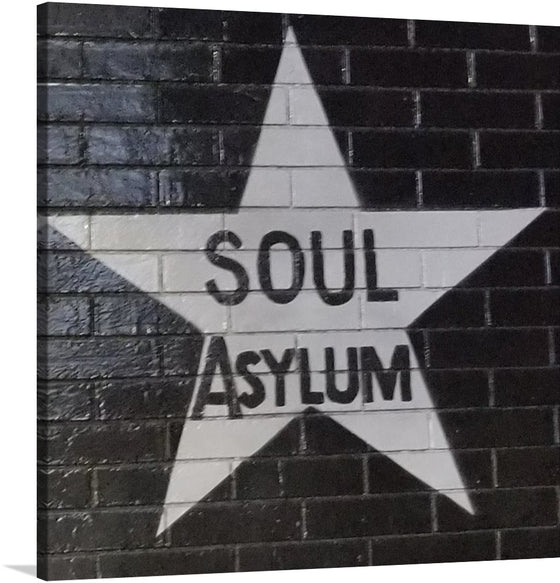 “Soul Asylum”: Immerse yourself in the captivating world of this artwork that effortlessly marries the raw energy of street art with the profound depths of soulful expression. Each print captures the stark contrast between the dark, textured brick background and the bold, white star that houses the evocative title. 