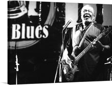  Immerse yourself in the electrifying atmosphere of the “Holmes Brothers at Liri Blues (2009)” with this exclusive print. The artwork captures a musician in full swing, his passion resonating with every strum on the bass guitar. The monochromatic tones encapsulate the timeless essence of blues, bringing the soul-stirring echoes of the festival into your space. This print is more than just an artwork; it’s a testament to the rich history of one of the main blues music festivals in Italy.