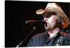 “Country music singer Toby Keith” is a beautiful print that captures the essence of country music. The image showcases the singer in his element, performing on stage with his signature cowboy hat. 