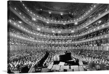  Immerse yourself in the grandeur of a bygone era with this exquisite print capturing a bustling, elegant concert hall. Every seat is filled, the audience in rapt attention, awaiting the maestro’s first command. The grand piano and sheet music stand poised on stage, echoing the anticipation of magical melodies soon to fill the air. The intricate architectural details of the hall and the collective anticipation of an unforgettable performance are forever encapsulated in this timeless piece. 