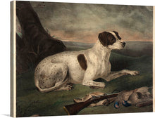  “Juno” is a captivating artwork by Nathaniel Currier that captures the serene and majestic essence of a dog in its natural habitat. The artwork features a white dog with brown spots lying on grass, appearing attentive and focused on something in the distance. In front of the dog are two birds and an old-fashioned rifle resting on the ground.