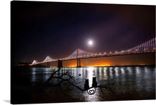  Introducing “Rincon Park at Night,” a mesmerizing print that captures a serene moment under the moonlit sky. This artwork features two cats, silhouetted against the radiant gleam of a full moon, sitting gracefully on a branch with their tails intertwined to form a heart. In the distance, the iconic bridge stands majestically, its lights reflecting off the tranquil waters below. 