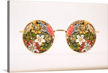  This whimsical artwork features a pair of sunglasses made entirely of flowers. The frames are made of a gold, and the lenses are made of brightly colored blooms. The overall effect is one of beauty and whimsy.