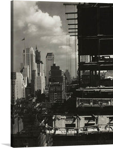  Step into a bygone era with this evocative print titled “My Window at An American Place, North (1931)” The artwork captures an urban scene during construction, with a large building under construction dominating the right side of the image. Its dark silhouette contrasts sharply with the expansive cityscape and the partly cloudy sky, creating a striking visual impact.