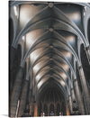 “Sant Fèlix, Sabadell, Spain” is a stunning print that captures the essence of gothic elegance and celestial serenity. The image features the interior architecture of Sant Fèlix church in Sabadell, Spain, with its intricately designed vaulted ceilings adorned with detailed gothic architectural elements. The stone columns rise majestically from the floor to support the ceiling, showcasing their ornate capitals.