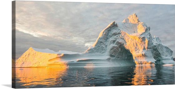 Experience the serene beauty of nature with this stunning print of a majestic iceberg bathed in the golden glow of the setting sun. This artwork captures a moment of tranquility, offering a glimpse into the pristine and untouched icy realms. The glistening waters reflecting the warm hues of sunset and the intricate formations of the iceberg are rendered with exquisite clarity. 