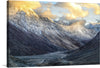 This exquisite print captures the serene majesty of a mountainous landscape bathed in the golden embrace of the setting sun. The towering peaks, cloaked in snow, stand as silent sentinels overlooking a tranquil valley where nature’s artistry is on full display. The interplay of light and shadow dances across the rugged terrain, illuminating the intricate textures and elevating this visual symphony to a masterpiece.