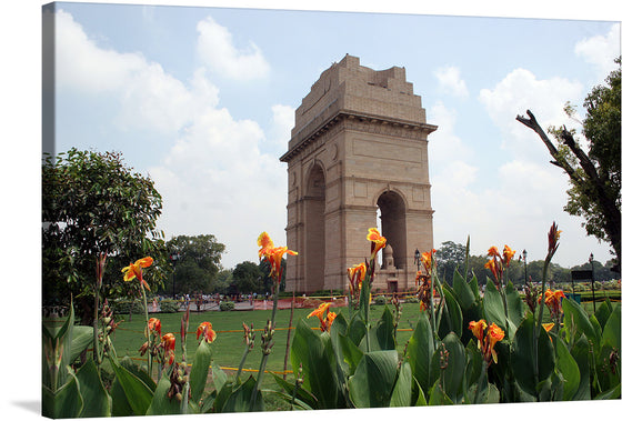 “India Gate, a WWI memorial in New Delhi, India” is a captivating artwork that brings the iconic monument to life. The print captures the majestic aura of this architectural masterpiece, standing tall amidst lush greenery and blooming flowers.