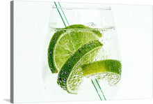  This print, titled “Iced Lime Soda,” is a refreshing dive into the simple beauty of nature. It features a close-up view of lime slices submerged in sparkling water, their bright green hues and textures accentuated against a stark white background. 