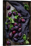 Closeup of fresh plums on a tray by Monika Grabkowska is a beautiful piece of food photography that captures the essence of fresh produce. The artwork features a close-up photo of ripe plums arranged on a tray, highlighting their vibrant colors and textures. 