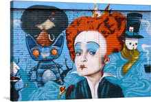  “The Red Queen” mural from the streets of Vitoria-Gasteiz beckons viewers into a whimsical and enigmatic realm. This vibrant artwork, now available as a limited edition print, captures the essence of a fantastical narrative. Amid swirling blues and rich textures, the central figure—a fiery-haired queen—commands attention. Her face remains veiled, adding an air of mystery. 