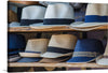 “Straw Hat Souvenirs” captures the timeless elegance and casual flair of summer. Each hat, meticulously woven, tells a story of sun-soaked days and balmy nights. The artwork showcases a variety of straw hats, each adorned with a distinct ribbon, offering a visual feast of textures and tones. 