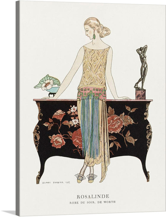 “Rosalinde: Robe du soir (1922)” by George Barbier is an exquisite print that captures the epitome of 1920s fashion and art deco style. The artwork features a woman adorned in an intricately designed evening gown, embodying grace and luxury. Every detail, from the floral backdrop to the elegant drapery of the dress, is meticulously crafted to transport you to an era where art and fashion were synonymous with opulence. 