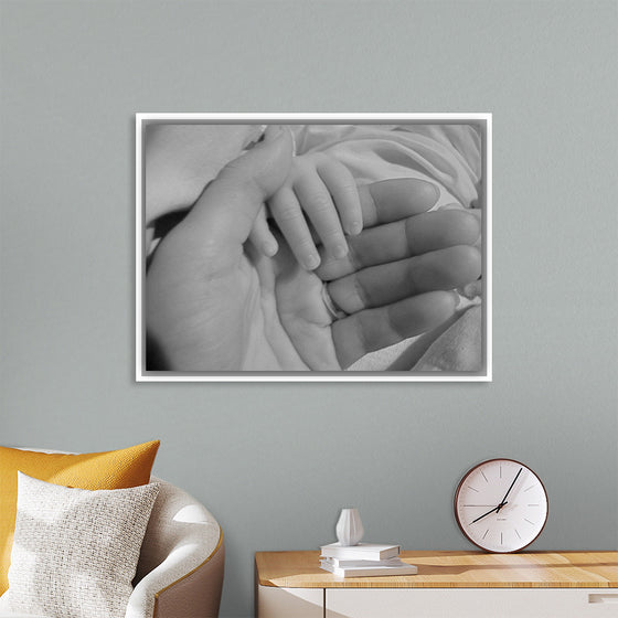 "Mother holding babys hand"