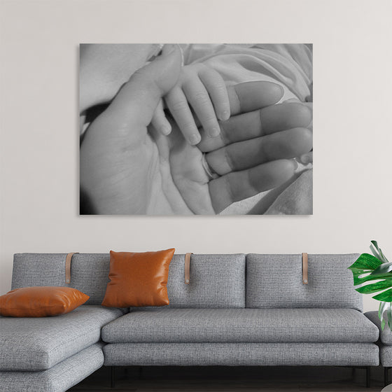 "Mother holding babys hand"