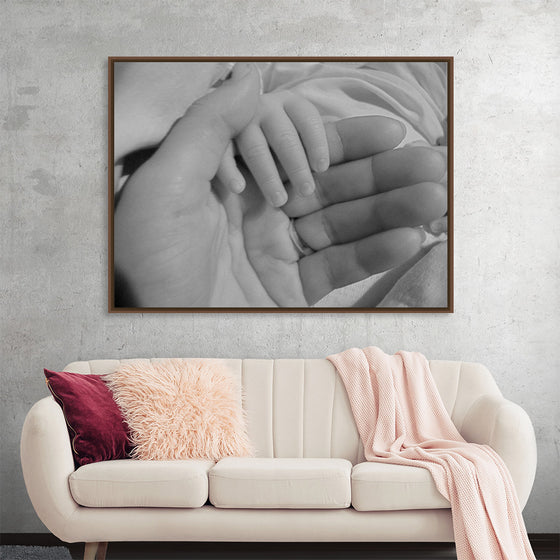 "Mother holding babys hand"