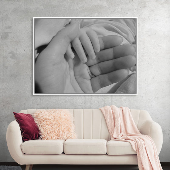 "Mother holding babys hand"