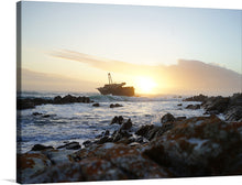  “L’Agulhas, South Africa” is a captivating print that captures the essence of the southernmost tip of Africa. The artwork portrays a breathtaking scene at L’Agulhas during sunset, where the azure waters reflect the clear skies and the rocky shores stand testament to the timeless battle between land and sea. 