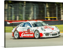   The artwork titled “Porsche Power” is a stunning representation of speed, precision, and luxury. The artwork features a white Porsche race car adorned with red graphics and text, captured in motion on a racetrack. The car’s design includes aerodynamic elements like spoilers for high-speed stability. 