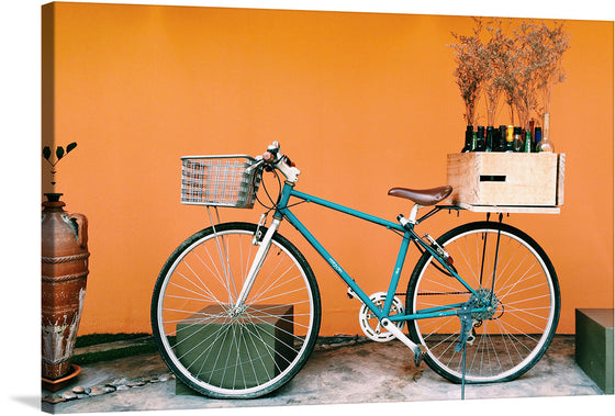 “Old Bicycle Meets Designer” is a captivating artwork that marries vintage charm with modern aesthetics. In this piece, an old yet elegant bicycle, painted in a rich teal hue, stands against a vibrant orange backdrop. The bicycle is not just a mode of transport but an artifact of simpler times, evoking nostalgia and warmth.