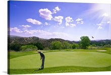   This print captures a golfer amidst his swing, surrounded by the lush greenery of an immaculate golf course. The vibrant greens and blues paint a picture of tranquility, while the sun casts its radiant beams from above, illuminating this moment of perfect harmony between man and nature. A lone bird soars in the distance under the vast sky dotted with fluffy clouds, adding a touch of freedom and expansiveness to this exquisite scene. 