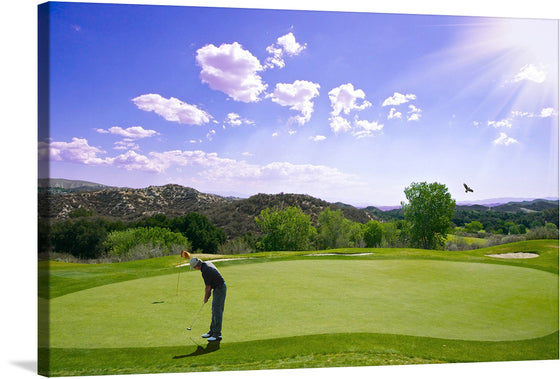  This print captures a golfer amidst his swing, surrounded by the lush greenery of an immaculate golf course. The vibrant greens and blues paint a picture of tranquility, while the sun casts its radiant beams from above, illuminating this moment of perfect harmony between man and nature. A lone bird soars in the distance under the vast sky dotted with fluffy clouds, adding a touch of freedom and expansiveness to this exquisite scene. 