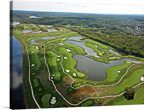 This captivating print offers an aerial view of a meticulously designed golf course, nestled amidst the embrace of nature. The lush green fairways, intricately woven between pristine lakes and bordered by forests, create a visual symphony of color and texture. Each curve and contour is a testament to the harmonious blend of man-made artistry and natural splendor. 