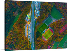  This stunning aerial view showcases the vibrant colors of the soccer pitches, while the sunlight reflects off the surrounding buildings, creating a mesmerizing spectacle. Step into this captivating image and let your imagination soar as you explore the dynamic intersection of sports and urban life.