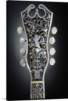  Immerse yourself in the intricate beauty of this exclusive artwork. This print captures the ornate headstock of a classic guitar, meticulously crafted with every curve, detail, and pattern showcasing an elegant dance between artistry and craftsmanship. The dark backdrop accentuates the white filigree design adorned with a cherub amidst floral elegance.