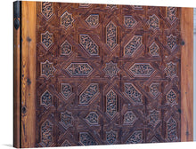  This intricate and beautiful wooden door detail from the Abenceraje Room in the Alhambra Palace in Granada, Spain is a stunning example of Moorish architecture and craftsmanship. The door is covered in intricate carvings of geometric patterns, stylized flowers, and Arabic inscriptions.